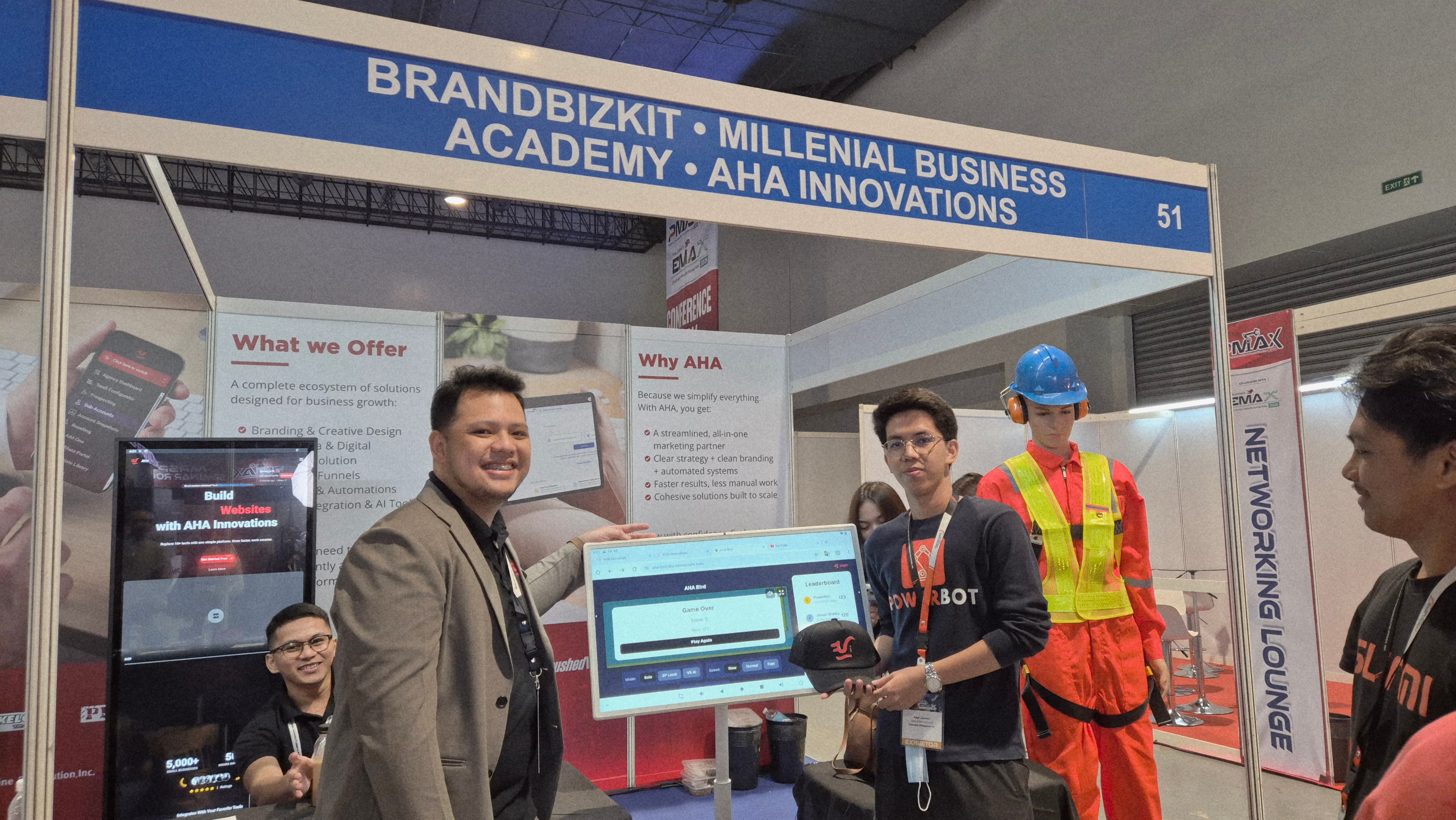 JC demonstrating AHA Innovations SaaS platform at PMAX booth with touchscreen display