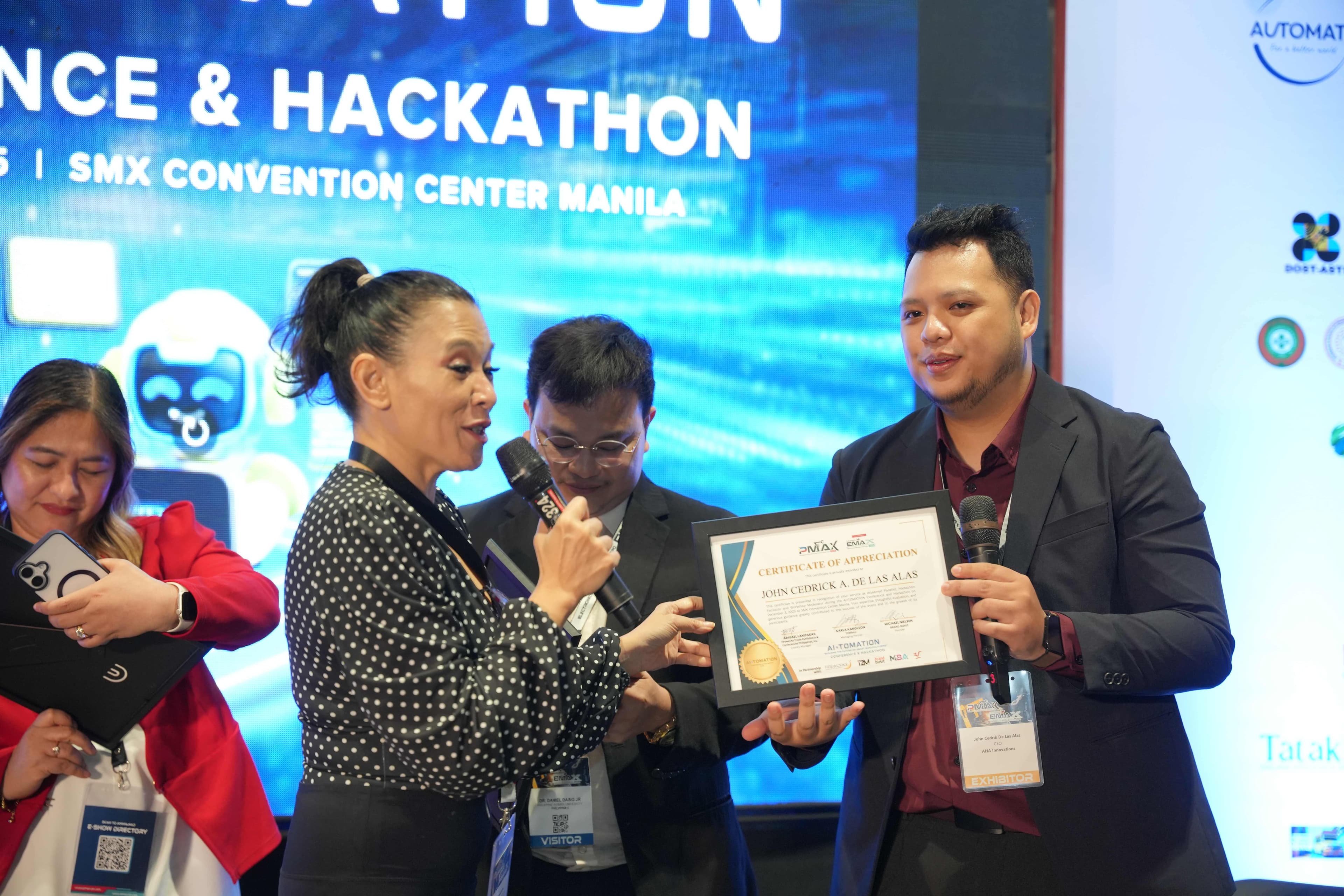 JC receiving Certificate of Appreciation on stage at AI-TOMATION Conference from event organizer