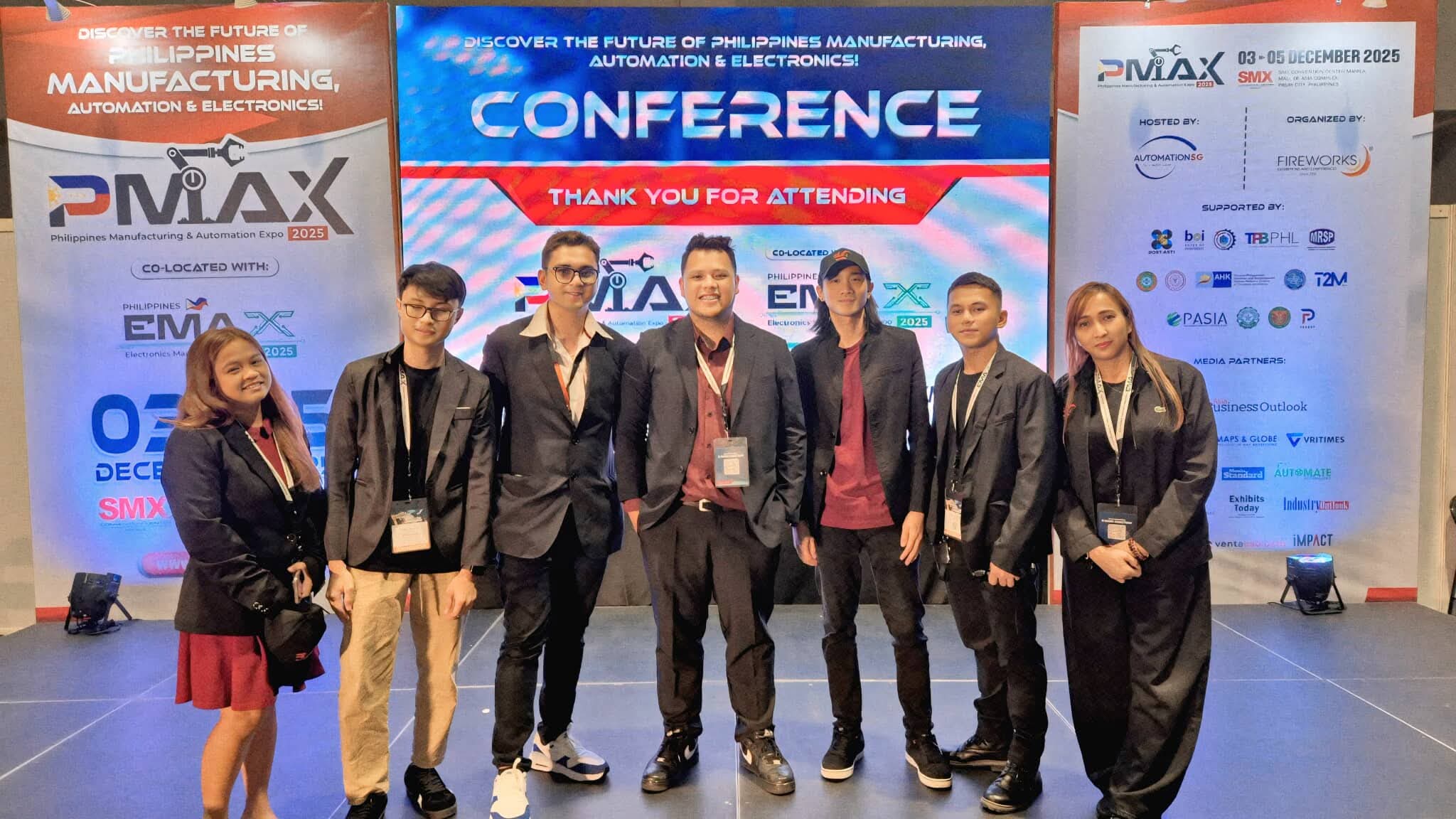 JC and team in front of PMAX 2025 Thank You for Attending conference backdrop on closing day